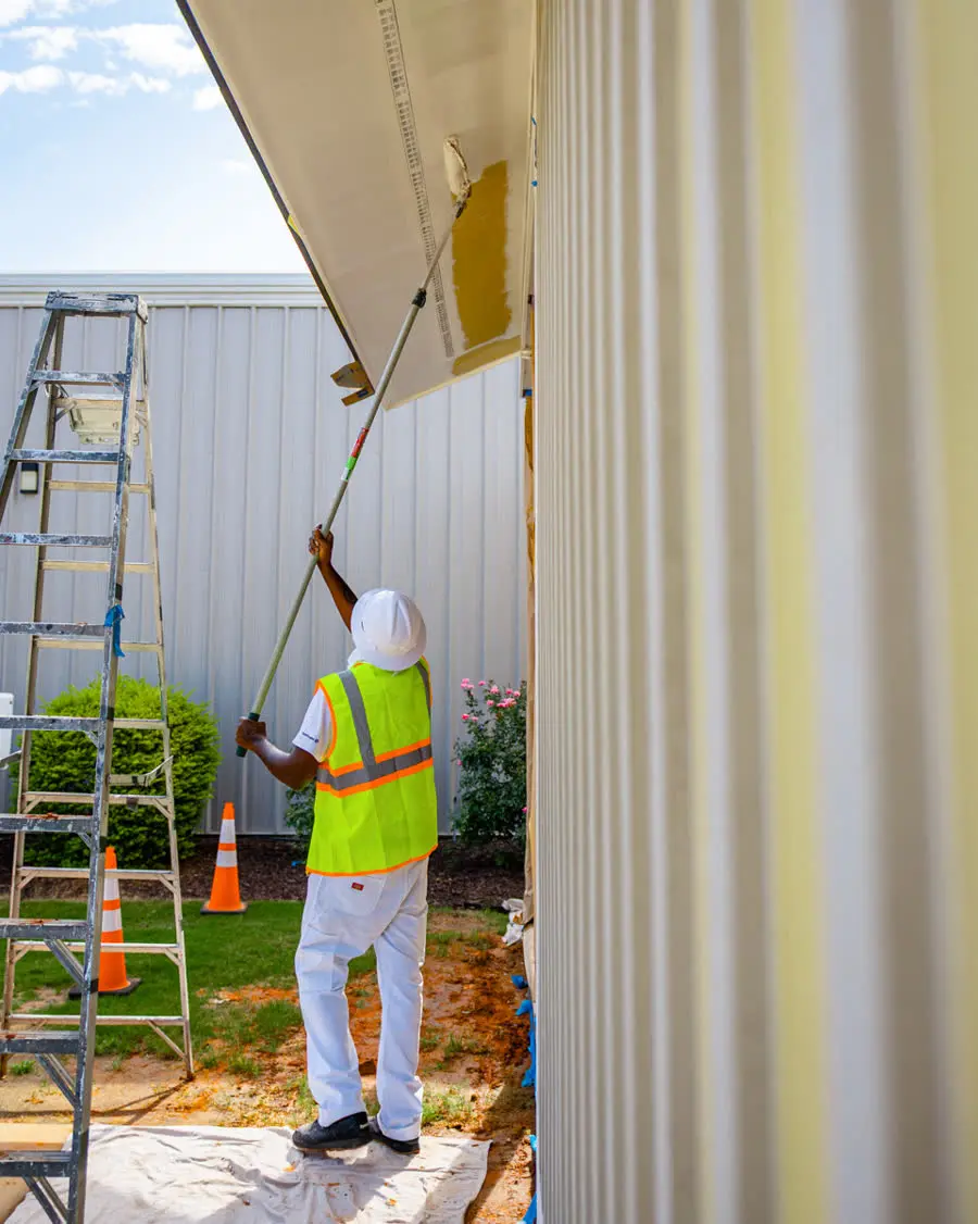 Painter working on a commercial building exterior
